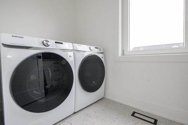 laundry area featuring washing machine and clothes dryer