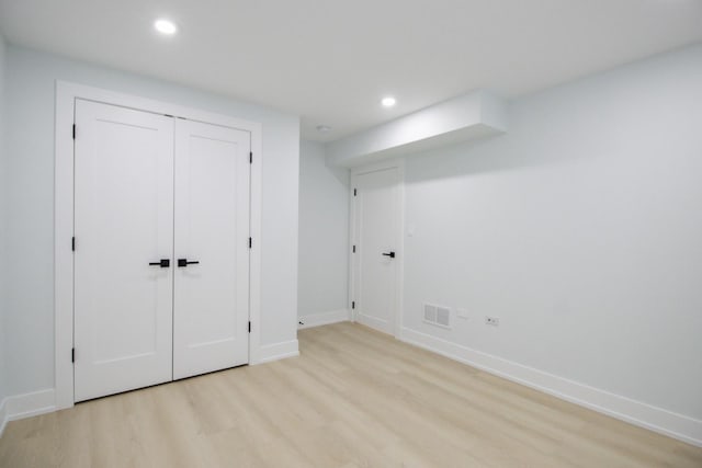 unfurnished bedroom featuring a closet and light hardwood / wood-style flooring