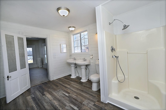 bathroom featuring walk in shower, sink, toilet, and hardwood / wood-style flooring