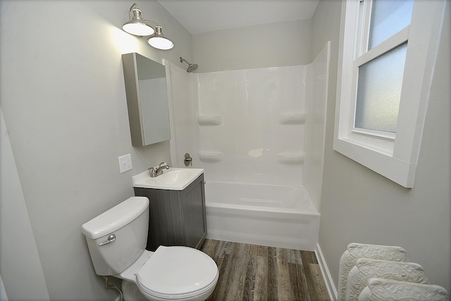 full bathroom featuring wood-type flooring, vanity, shower / bath combination, and toilet