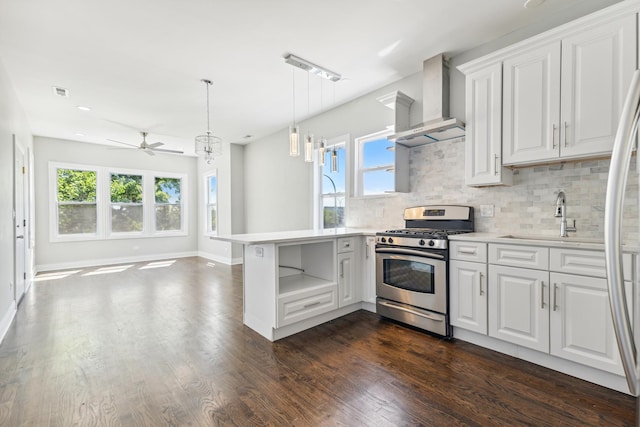 kitchen with kitchen peninsula, stainless steel appliances, white cabinets, and wall chimney exhaust hood