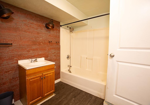 bathroom with vanity, hardwood / wood-style floors, and  shower combination