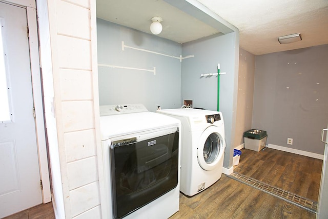 laundry room with dark wood-type flooring and washing machine and dryer