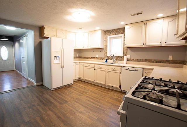 kitchen featuring white cabinetry, white appliances, dark wood-type flooring, and sink