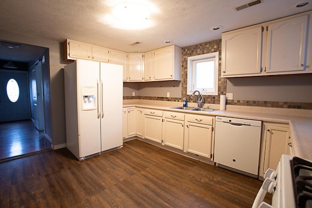 kitchen featuring dark hardwood / wood-style flooring, sink, white cabinets, and white appliances