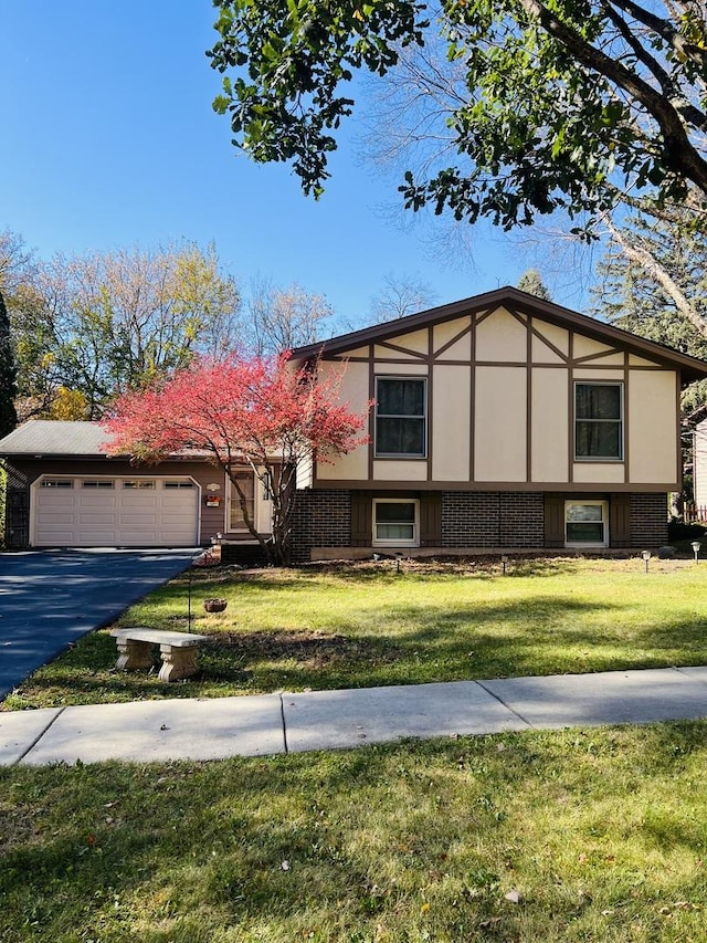 view of front of house with a garage and a front lawn