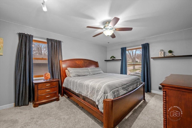 bedroom featuring ceiling fan and light colored carpet