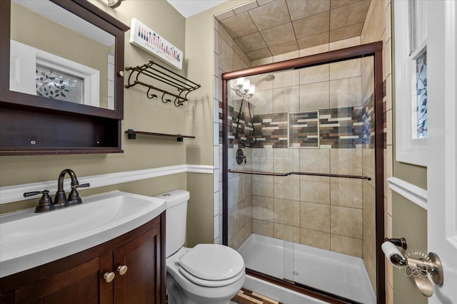 bathroom with vanity, toilet, and walk in shower