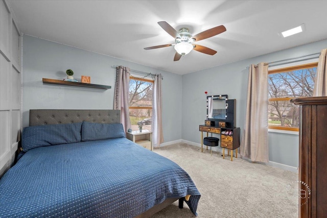 bedroom featuring light carpet and ceiling fan