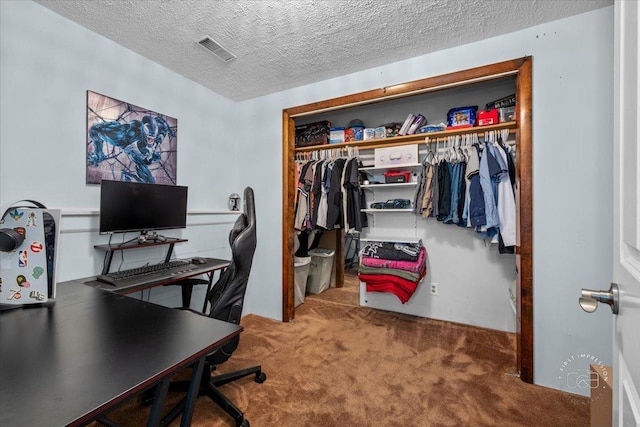 home office with carpet and a textured ceiling