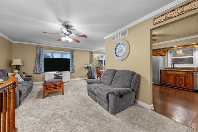 living room featuring sink, carpet floors, and ornamental molding