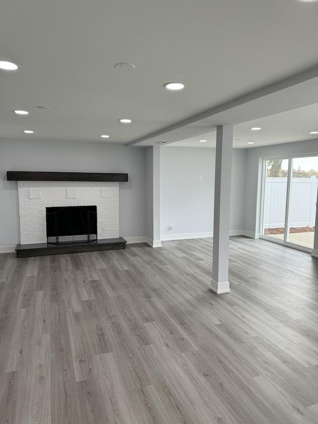 unfurnished living room with a fireplace and light hardwood / wood-style flooring