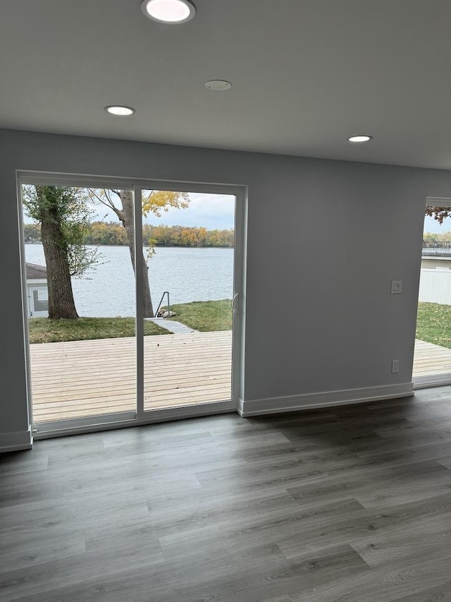 doorway to outside with wood-type flooring and a water view