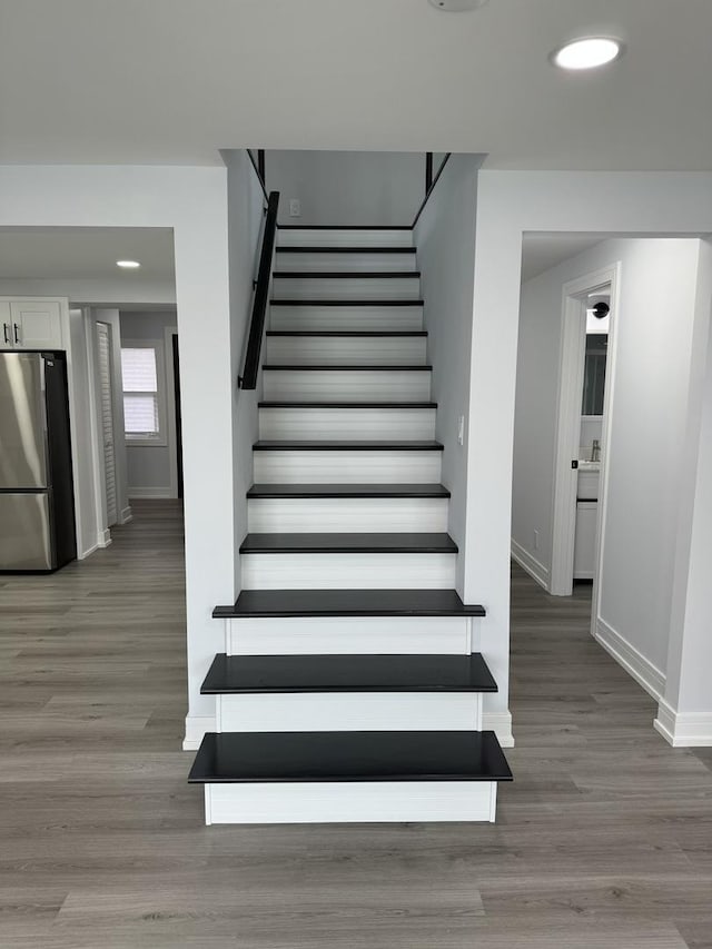 staircase with wood-type flooring