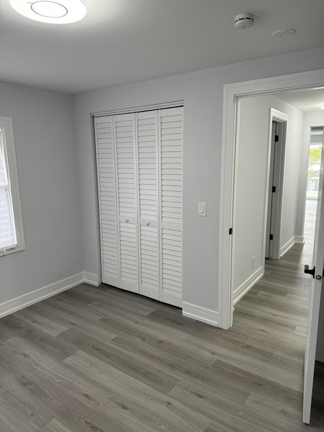 unfurnished bedroom featuring a closet and light hardwood / wood-style flooring