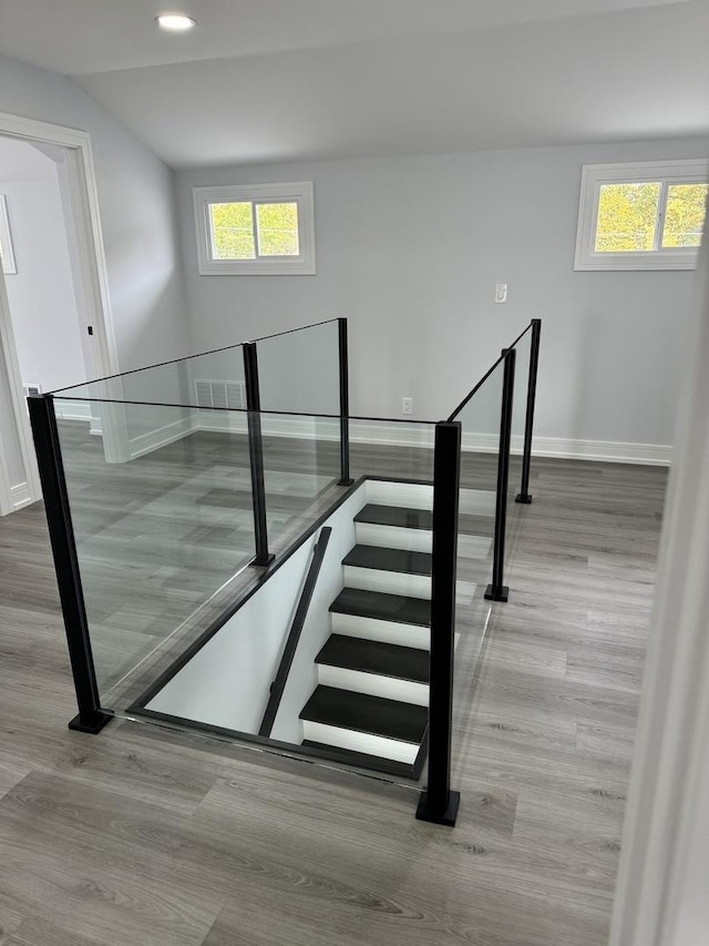 stairs featuring hardwood / wood-style floors