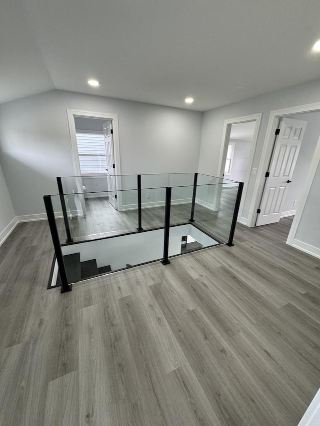 interior space featuring hardwood / wood-style flooring and lofted ceiling