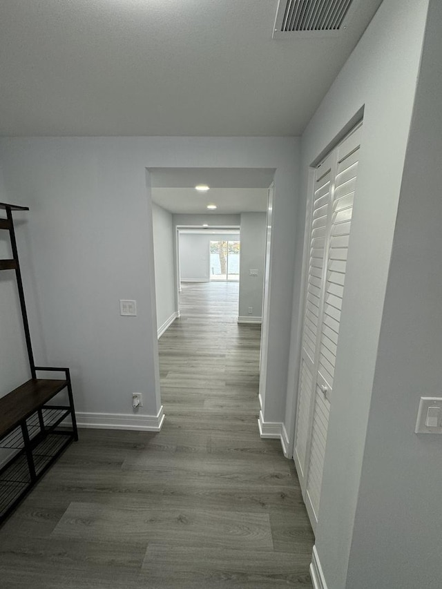 hallway with hardwood / wood-style flooring