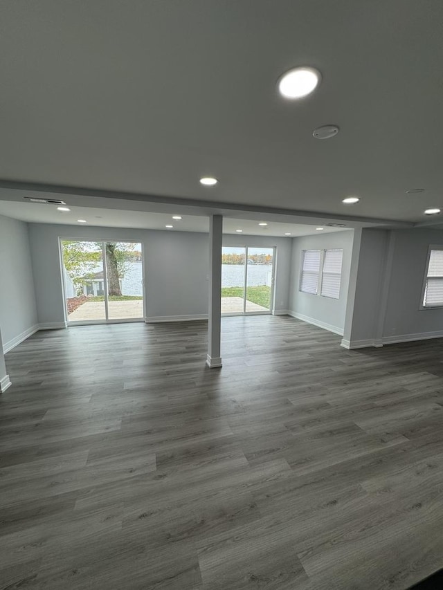 unfurnished room with dark wood-type flooring