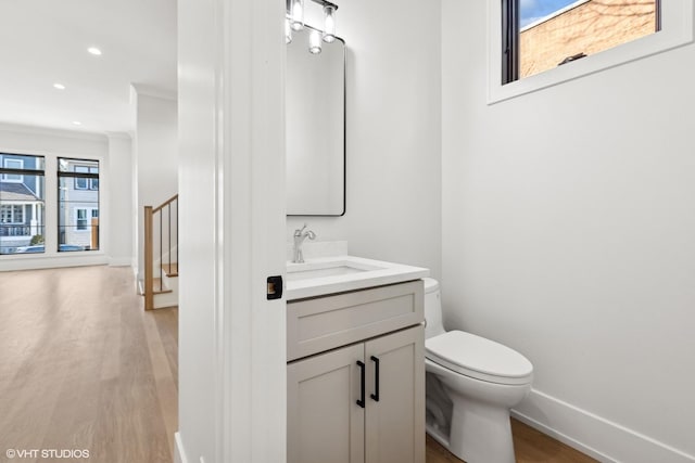 bathroom featuring hardwood / wood-style flooring, vanity, and toilet