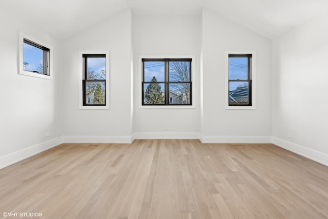 empty room featuring lofted ceiling and light hardwood / wood-style floors