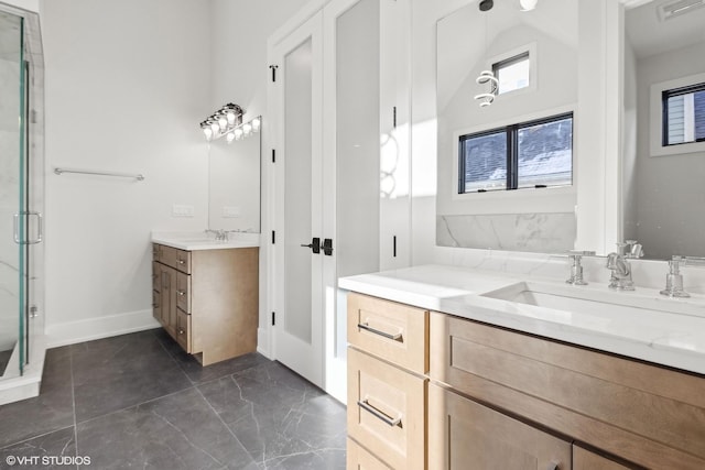 bathroom with a shower with door and vanity