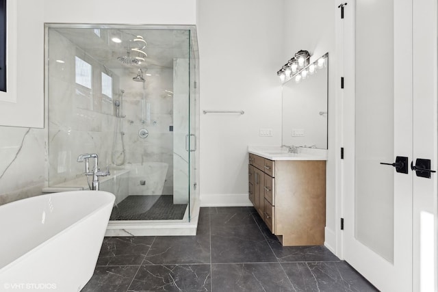 bathroom with vanity and separate shower and tub