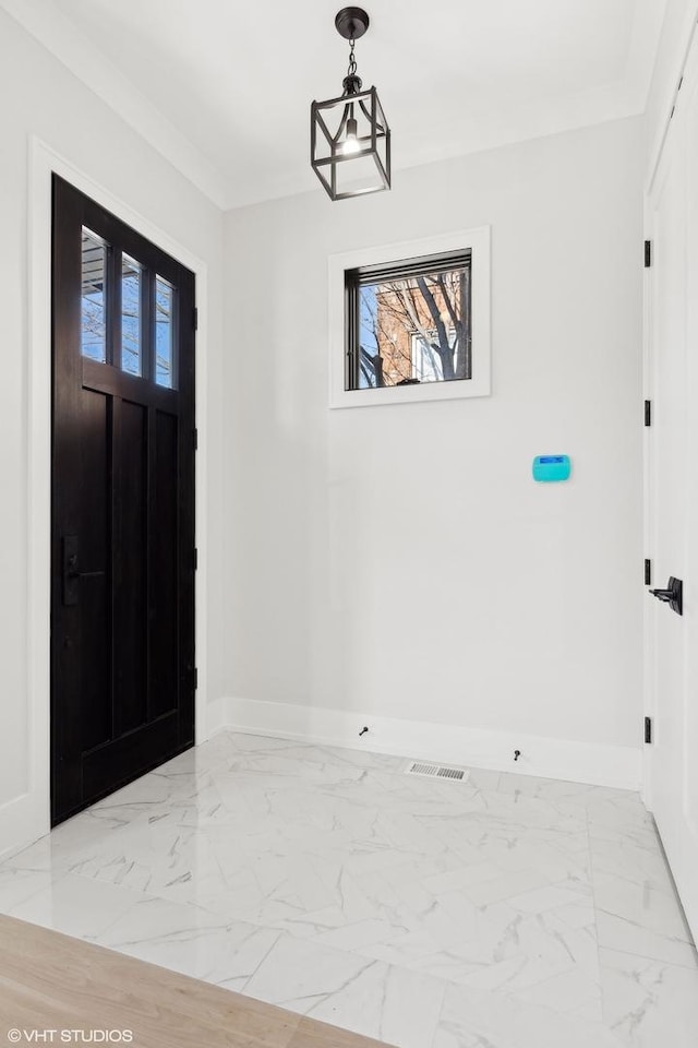 foyer entrance with ornamental molding