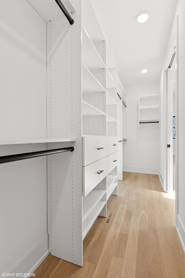 walk in closet with light wood-type flooring