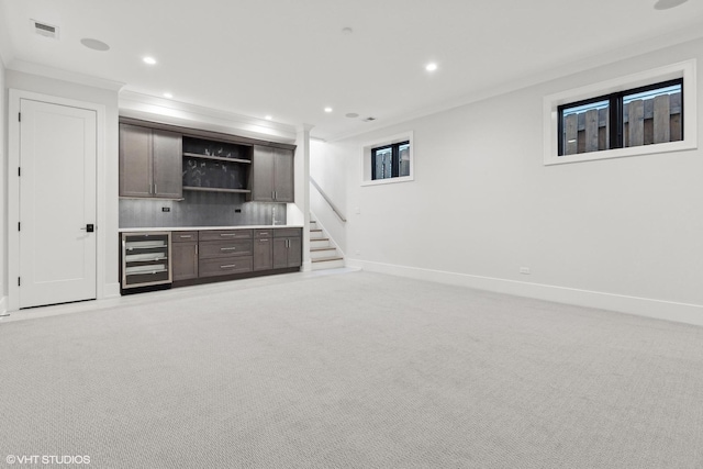 bar with crown molding, dark brown cabinetry, wine cooler, tasteful backsplash, and light colored carpet