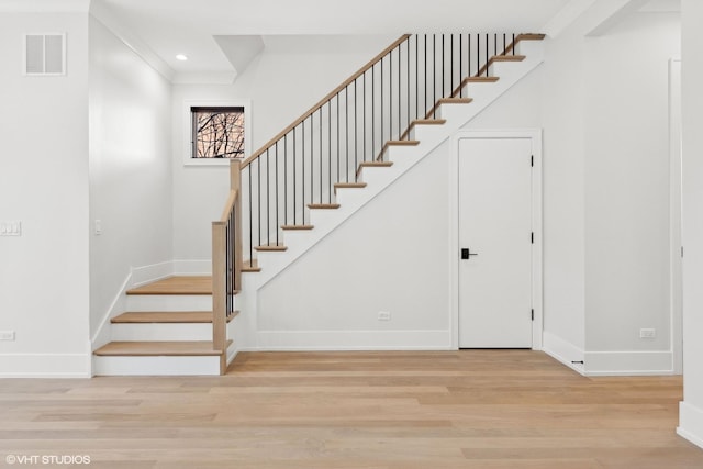 stairway with hardwood / wood-style flooring