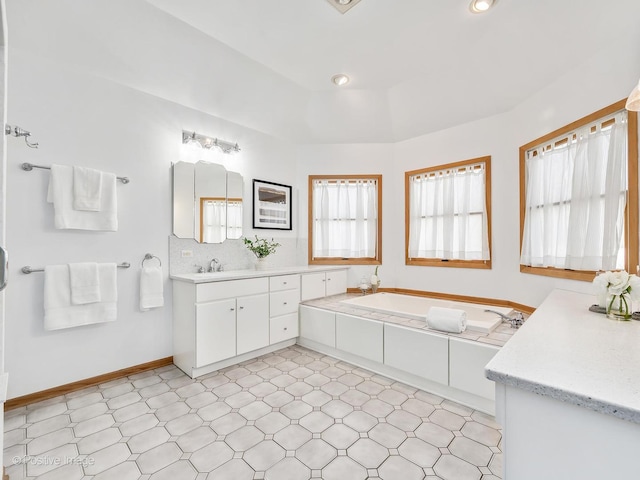 bathroom featuring vanity and backsplash