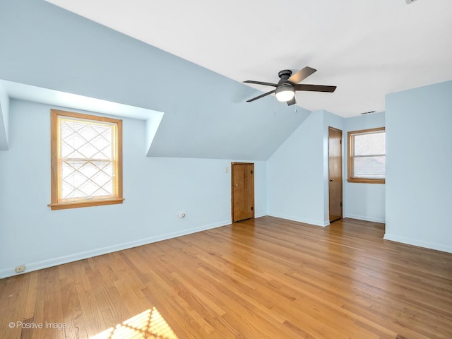 bonus room with ceiling fan, light hardwood / wood-style flooring, and vaulted ceiling