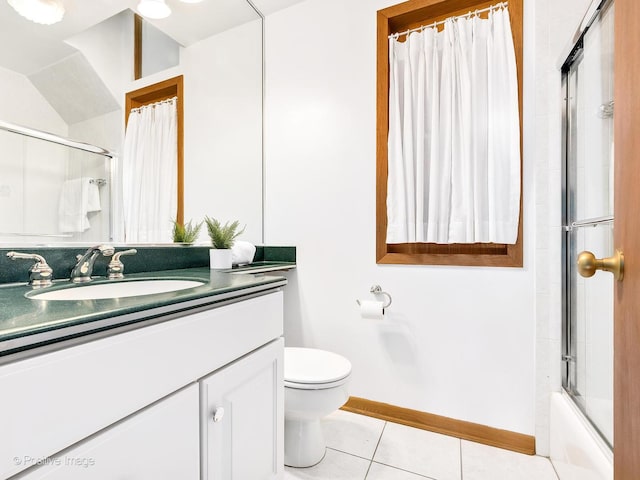 full bathroom featuring shower / bath combination with glass door, tile patterned flooring, vanity, and toilet