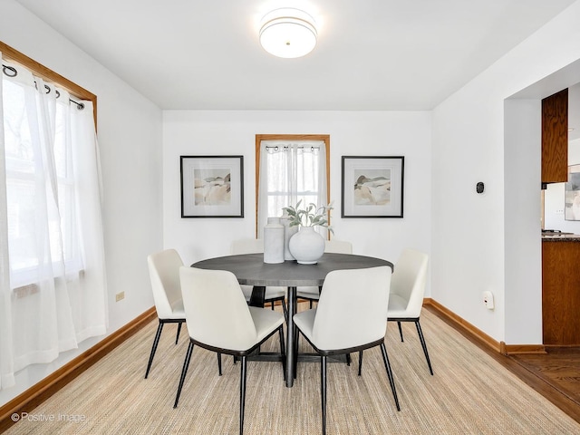 dining space with light hardwood / wood-style floors