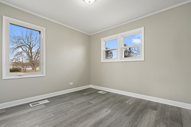 empty room with crown molding and dark wood-type flooring