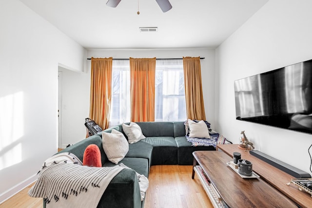 living room with ceiling fan and light hardwood / wood-style floors