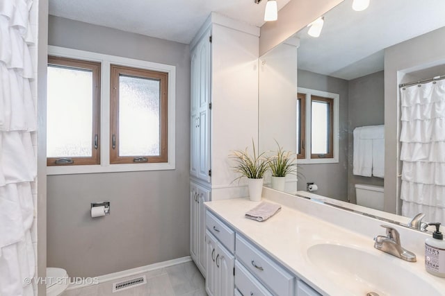 bathroom featuring tile patterned floors, vanity, and toilet