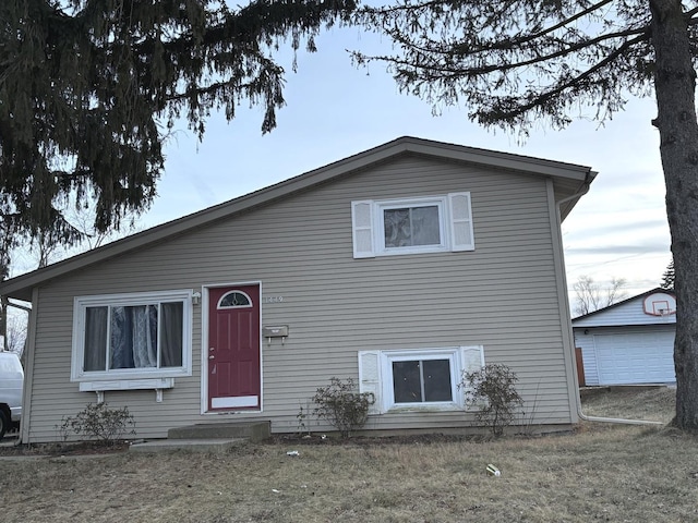 view of front facade featuring an outbuilding and a garage