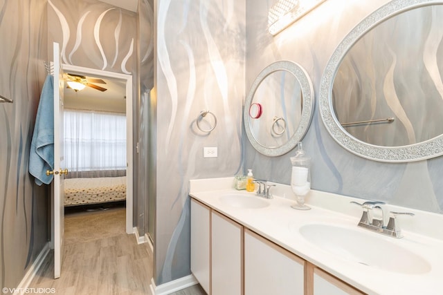 bathroom with hardwood / wood-style flooring, vanity, and ceiling fan