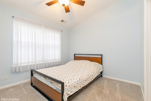 carpeted bedroom with ceiling fan and lofted ceiling