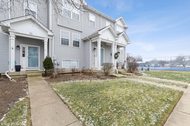 view of property featuring a front lawn