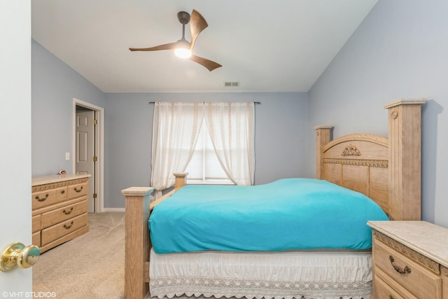 carpeted bedroom with vaulted ceiling and ceiling fan