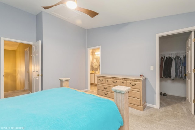 bedroom with light carpet, ensuite bathroom, ceiling fan, a spacious closet, and a closet