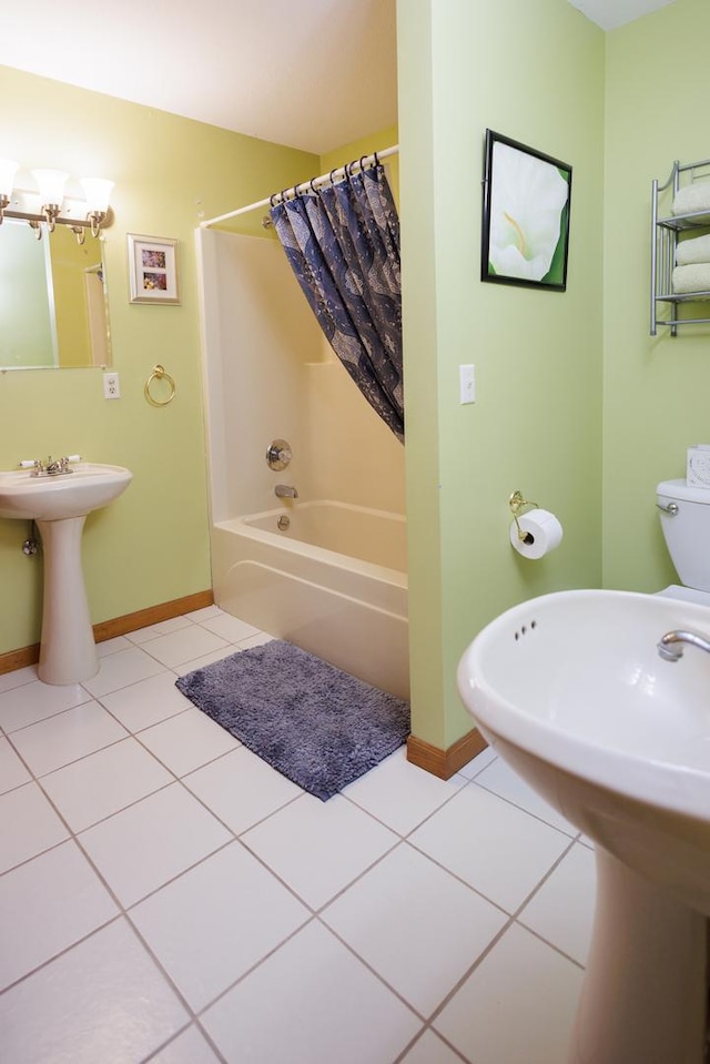 bathroom with shower / bath combo, baseboards, tile patterned flooring, a notable chandelier, and a sink