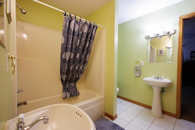 bathroom with tile patterned flooring, baseboards, shower / bathtub combination with curtain, and toilet