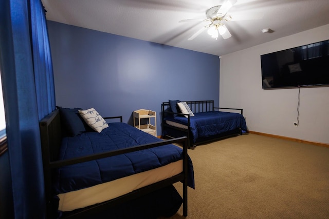 bedroom featuring carpet, baseboards, and a ceiling fan