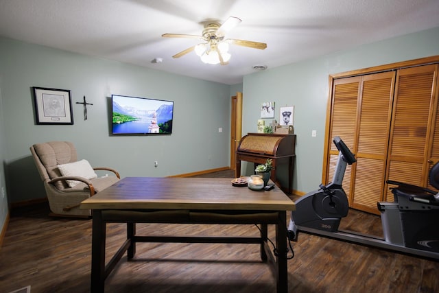 home office with ceiling fan and dark wood-type flooring