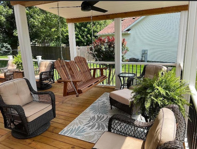 wooden terrace with fence and a ceiling fan