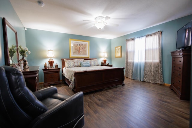 bedroom with ceiling fan, dark wood finished floors, and baseboards